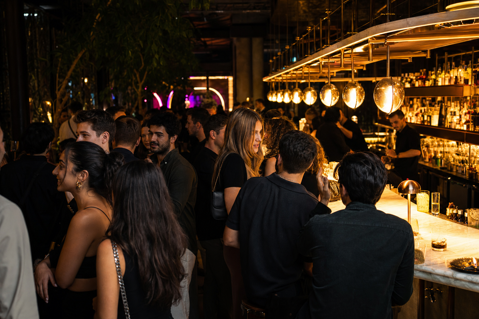 A packed bar full of people talking face to face